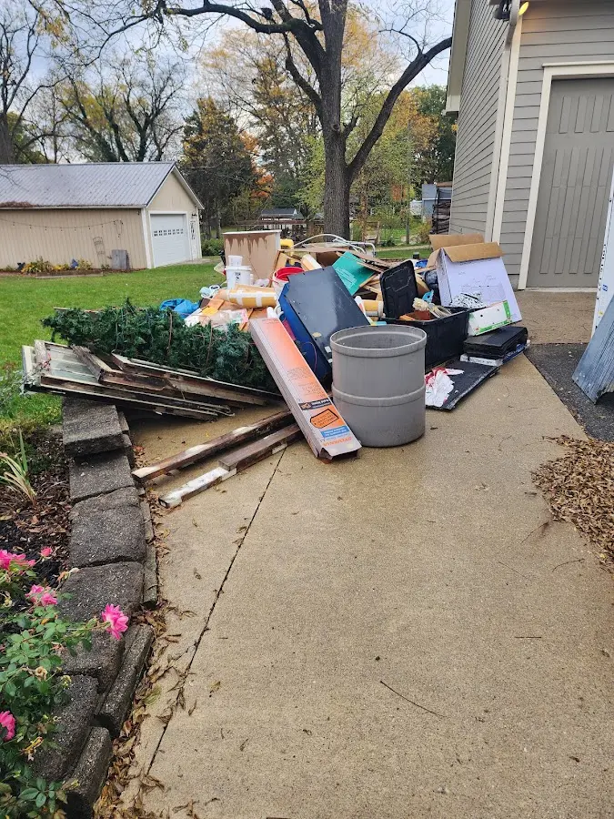Dumpster being loaded with debris for Roofing Dumpster Rental in Summerside